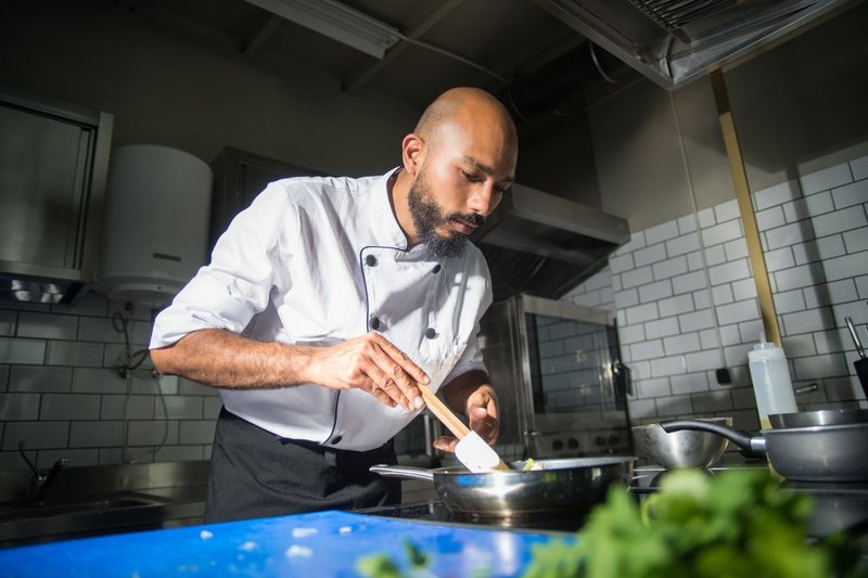 Chef cooking in a restaurant kitchen - real food photos for restaurant SEO